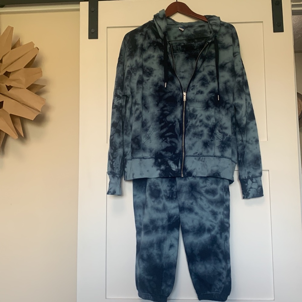 Complete track suit, pants have slash pockets and super comfortable.